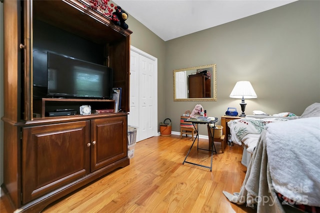 bedroom featuring light wood-style flooring and baseboards