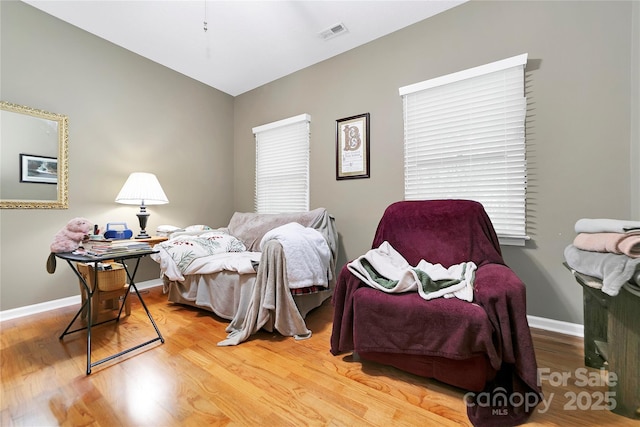 bedroom featuring wood finished floors and baseboards