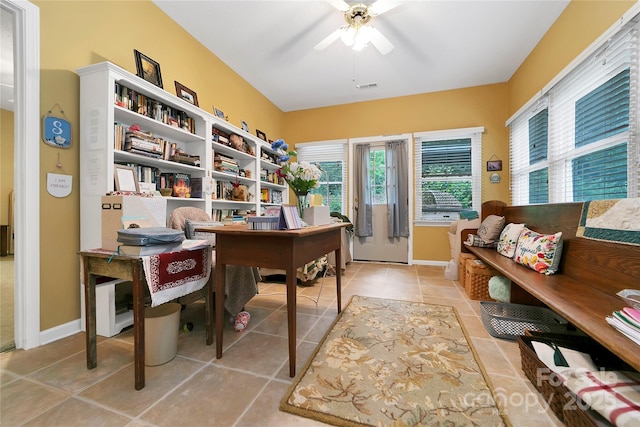 home office featuring ceiling fan, light tile patterned floors, and baseboards