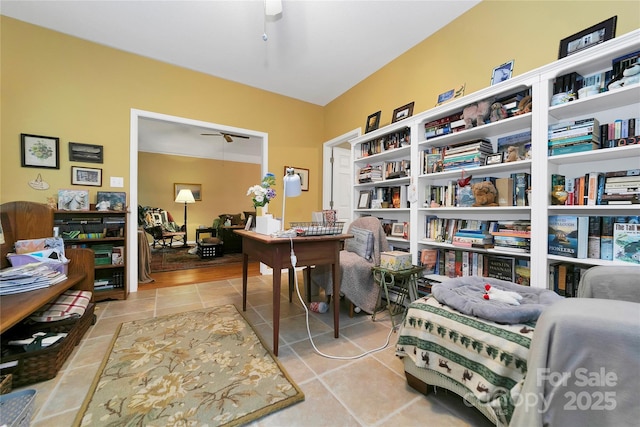 tiled office space featuring a ceiling fan