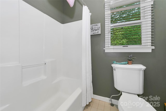 full bathroom with tile patterned flooring, baseboards, and toilet