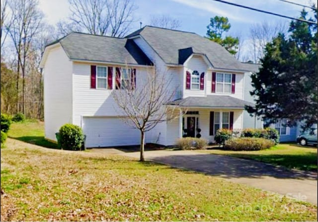 10016 Lawing School Rd, Charlotte, NC 28214 - view of front of property featuring driveway, a front lawn, an attached garage, and covered porch