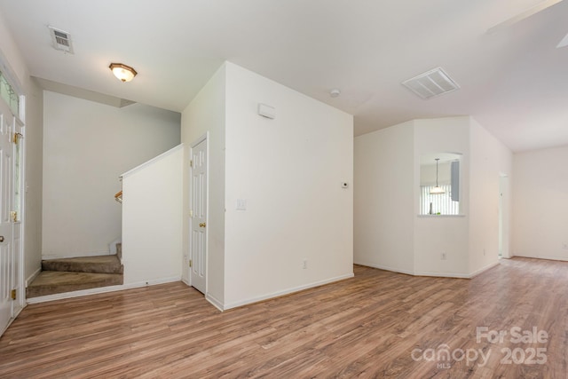 10016 Lawing School Rd, Charlotte, NC 28214 - unfurnished room featuring stairs, wood finished floors, and healthy amount of natural light