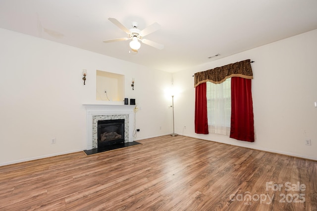 10016 Lawing School Rd, Charlotte, NC 28214 - unfurnished living room with a tile fireplace, wood finished floors, and a ceiling fan