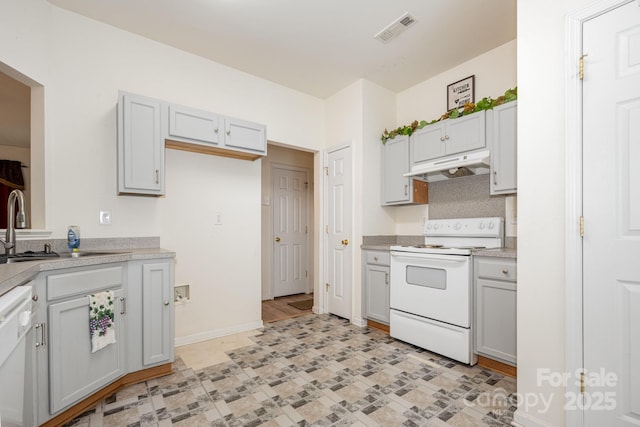 10016 Lawing School Rd, Charlotte, NC 28214 - kitchen with white appliances, under cabinet range hood, light countertops, and gray cabinets