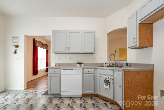 10016 Lawing School Rd, Charlotte, NC 28214 - kitchen with dishwasher, arched walkways, gray cabinets, and light countertops