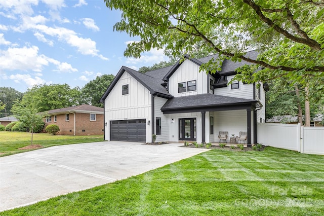 9527 Walkers Ferry Rd, Charlotte, NC 28214 - modern farmhouse style home featuring board and batten siding, an attached garage, concrete driveway, roof with shingles, and a gate