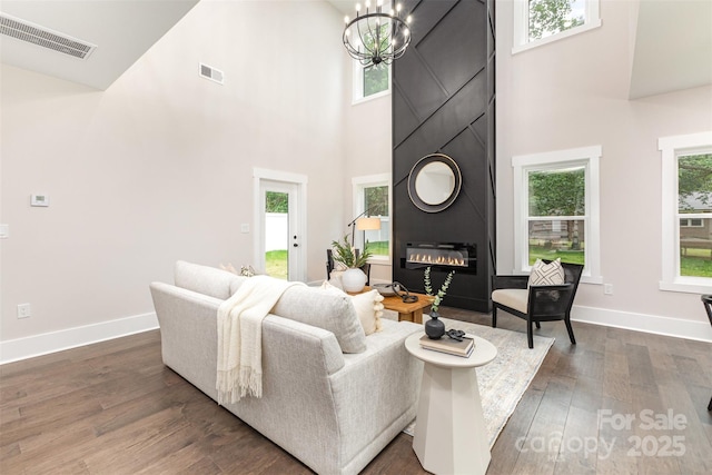 9527 Walkers Ferry Rd, Charlotte, NC 28214 - living area with a towering ceiling, a large fireplace, and wood finished floors