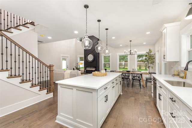 9527 Walkers Ferry Rd, Charlotte, NC 28214 - kitchen with dark wood finished floors, light countertops, white cabinets, recessed lighting, and a center island