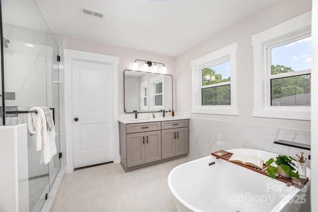 9527 Walkers Ferry Rd, Charlotte, NC 28214 - full bath featuring vanity, a marble finish shower, and a freestanding tub