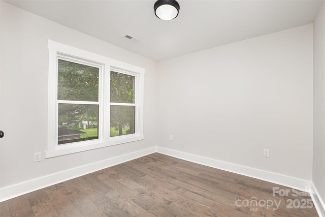 9527 Walkers Ferry Rd, Charlotte, NC 28214 - spare room featuring baseboards and dark wood-style flooring