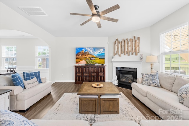 191 Tackle Box Dr, Troutman, NC 28166 - living room featuring ceiling fan, dark wood finished floors, arched walkways, a glass covered fireplace, and baseboards