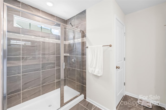 191 Tackle Box Dr, Troutman, NC 28166 - bathroom with a stall shower, baseboards, and tile patterned flooring
