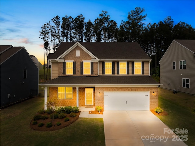 191 Tackle Box Dr, Troutman, NC 28166 - traditional-style house featuring brick siding, concrete driveway, a garage, and a front lawn
