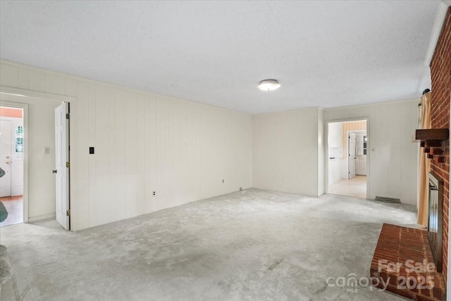 8017 Prince George Rd, Charlotte, NC 28210 - unfurnished living room with a fireplace, carpet floors, and wooden walls