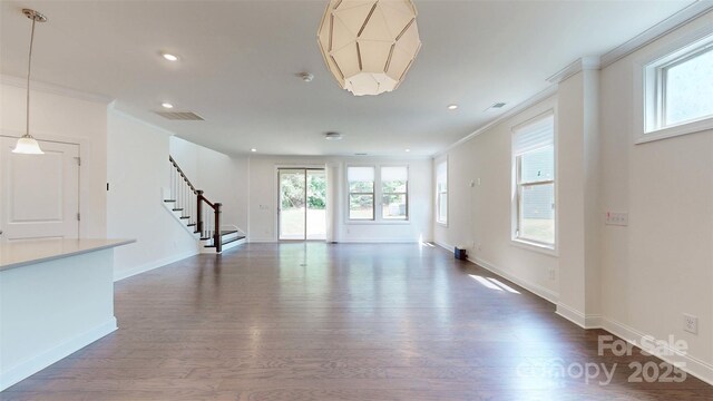 14506 Knowledge Cir, Charlotte, NC 28277 - unfurnished living room with crown molding, stairway, dark wood-style floors, recessed lighting, and baseboards