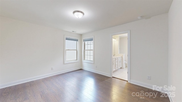 14506 Knowledge Cir, Charlotte, NC 28277 - unfurnished bedroom with dark wood finished floors, baseboards, and ensuite bathroom