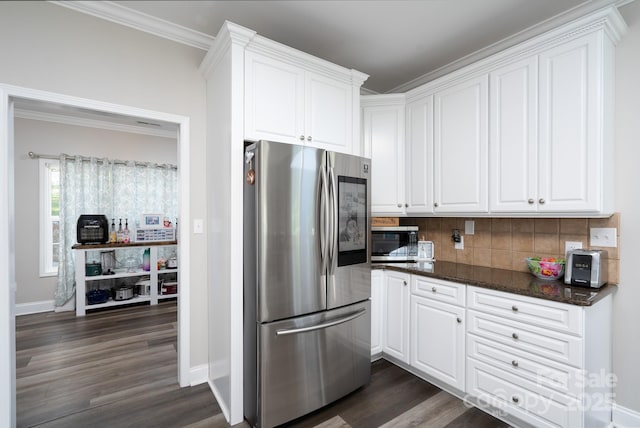 126 Strand Rd, New London, NC 28127 - kitchen featuring appliances with stainless steel finishes, dark wood finished floors, decorative backsplash, white cabinets, and ornamental molding