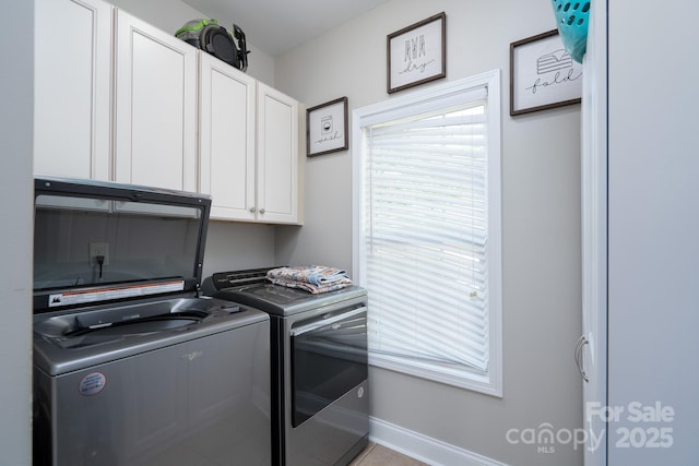 126 Strand Rd, New London, NC 28127 - clothes washing area featuring cabinet space, washer and clothes dryer, and baseboards