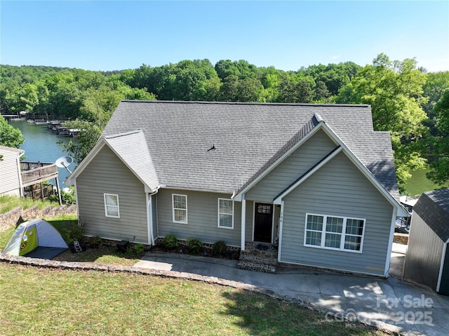 126 Strand Rd, New London, NC 28127 - single story home featuring a water view, a shingled roof, a front lawn, and a wooded view