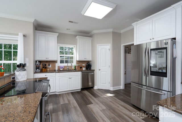 126 Strand Rd, New London, NC 28127 - kitchen with appliances with stainless steel finishes, a sink, white cabinetry, dark wood-type flooring, and ornamental molding