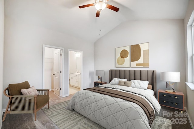 carpeted bedroom with lofted ceiling, ensuite bathroom, baseboards, and a ceiling fan