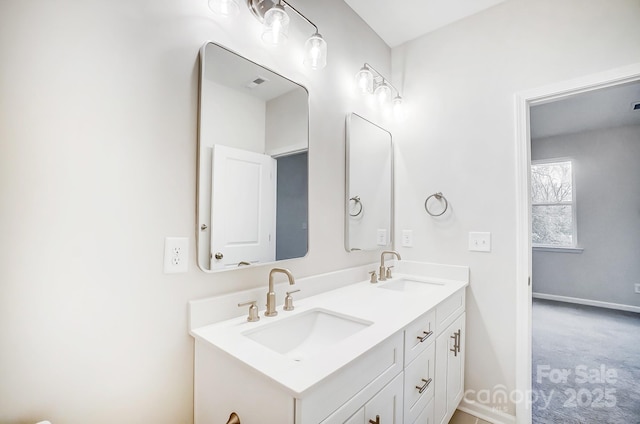 full bathroom featuring baseboards, visible vents, double vanity, and a sink