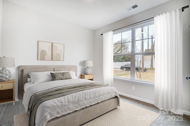bedroom featuring carpet flooring, visible vents, and baseboards