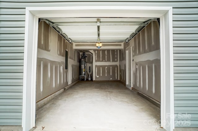garage featuring electric water heater and electric panel