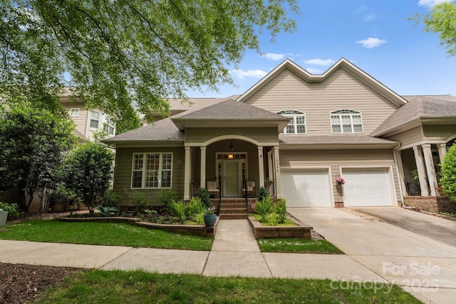 view of front of home featuring concrete driveway, an attached garage, and a shingled roof