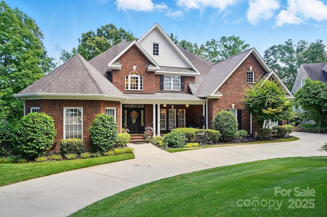5718 Bardsey Ct, Matthews, NC 28104 - traditional-style house with brick siding, a front lawn, and roof with shingles