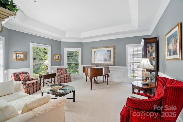 5718 Bardsey Ct, Matthews, NC 28104 - carpeted living area with a tray ceiling, wainscoting, a decorative wall, and ornamental molding