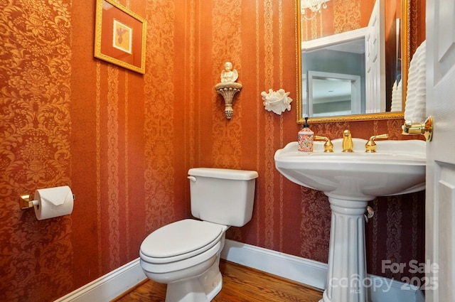 5718 Bardsey Ct, Matthews, NC 28104 - bathroom with wood finished floors, toilet, wallpapered walls, and baseboards