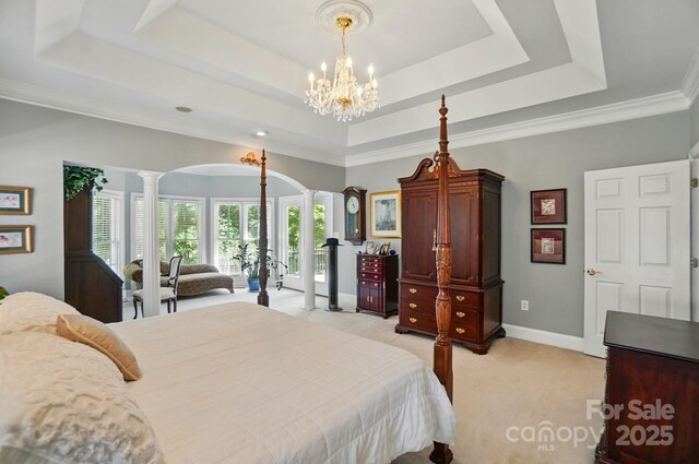 5718 Bardsey Ct, Matthews, NC 28104 - bedroom featuring decorative columns, a tray ceiling, arched walkways, light carpet, and baseboards