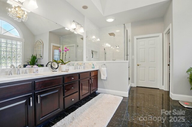 5718 Bardsey Ct, Matthews, NC 28104 - bathroom with granite floors, a shower stall, double vanity, a chandelier, and baseboards