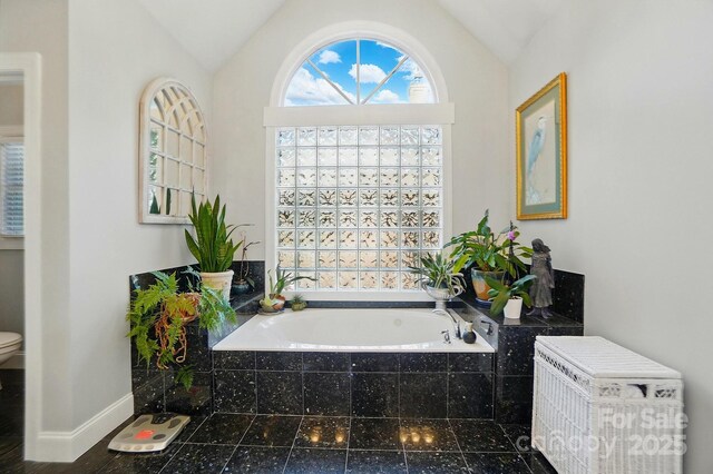 5718 Bardsey Ct, Matthews, NC 28104 - bathroom featuring a bath, lofted ceiling, toilet, and baseboards