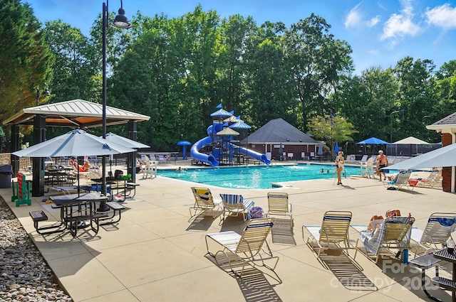 5718 Bardsey Ct, Matthews, NC 28104 - community pool featuring a water slide, a gazebo, a patio area, and view of wooded area