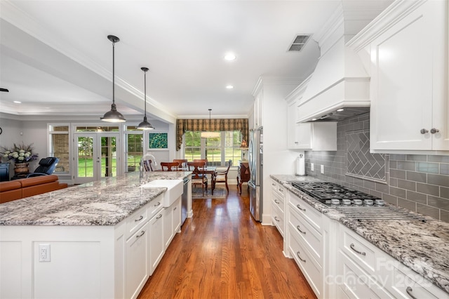 1010 Nutall Oak Ln, Belmont, NC 28012 - kitchen with visible vents, a sink, open floor plan, stainless steel appliances, and white cabinets