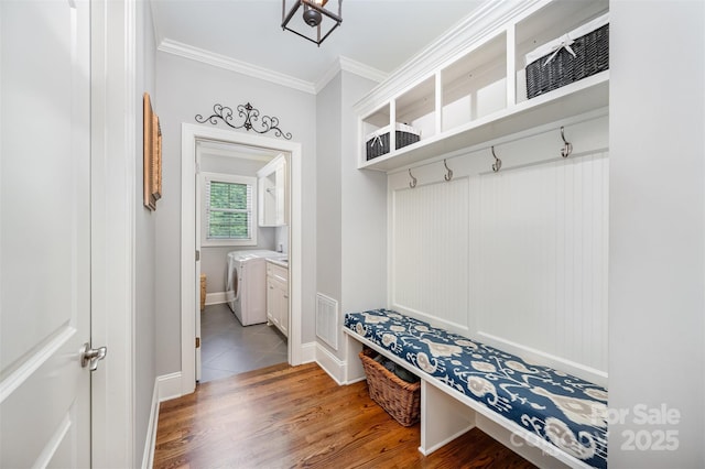 1010 Nutall Oak Ln, Belmont, NC 28012 - mudroom featuring wood finished floors, ornamental molding, visible vents, separate washer and dryer, and baseboards