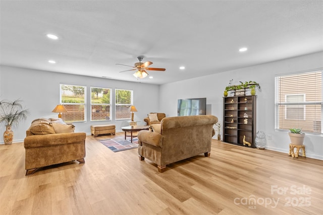 living area with light wood-style flooring, recessed lighting, ceiling fan, and baseboards