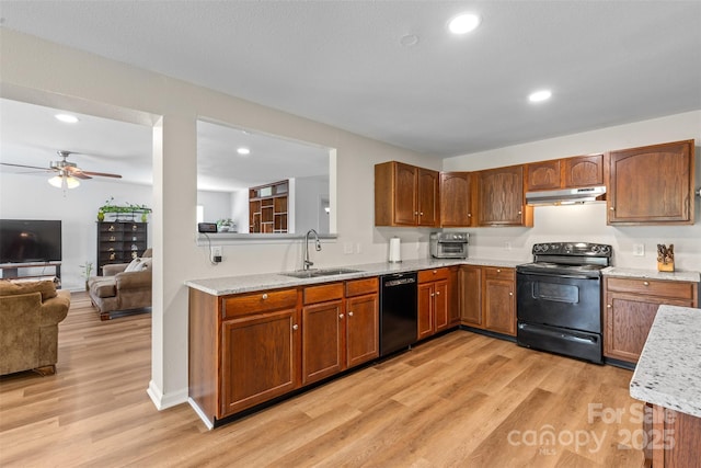 kitchen with black appliances, a sink, under cabinet range hood, a ceiling fan, and light wood-type flooring
