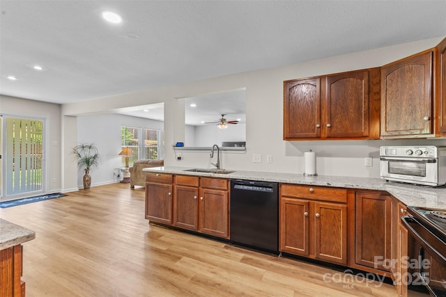 kitchen featuring black appliances, a sink, recessed lighting, light wood-style flooring, and a ceiling fan