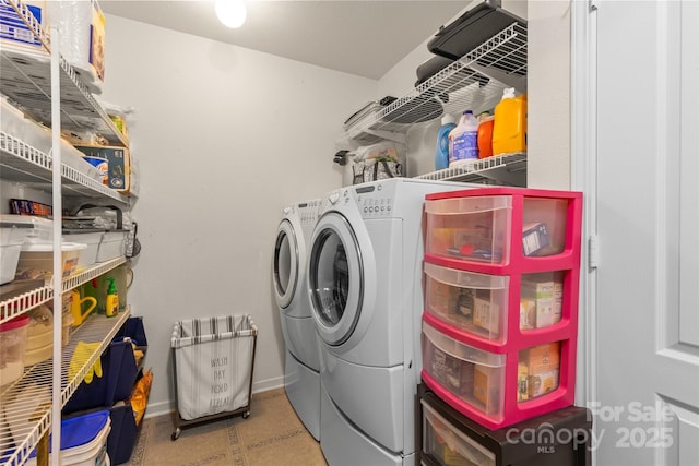 washroom with separate washer and dryer and baseboards