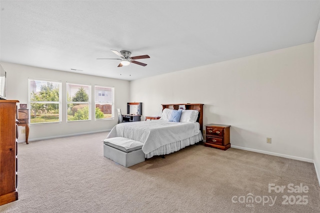 carpeted bedroom with baseboards and a ceiling fan
