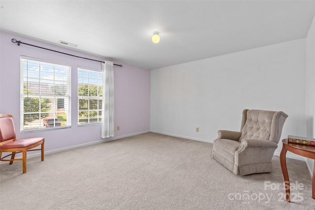 living area with carpet flooring and baseboards