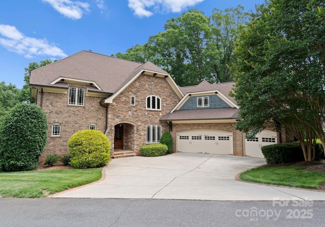 3815 Stoney Ridge Trl, Charlotte, NC 28210 - view of front of house with a garage, driveway, brick siding, and a shingled roof