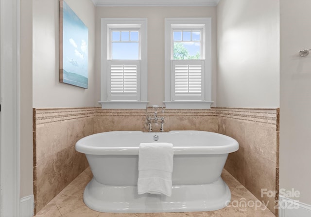 3815 Stoney Ridge Trl, Charlotte, NC 28210 - bathroom featuring tile walls, a soaking tub, and wainscoting