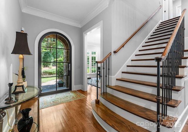12835 Ninebark Trl, Charlotte, NC 28278 - foyer featuring wood finished floors, stairs, crown molding, and baseboards