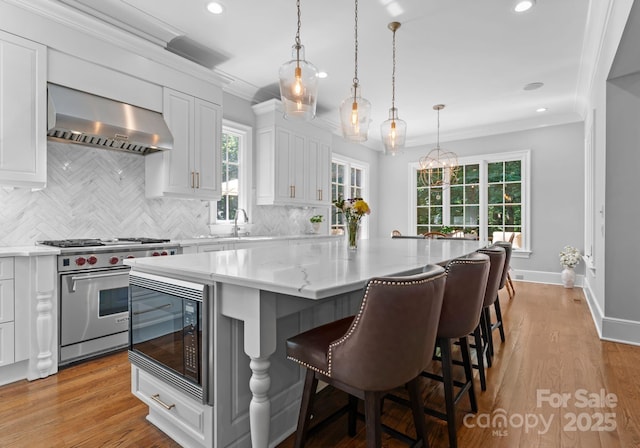 12835 Ninebark Trl, Charlotte, NC 28278 - kitchen with extractor fan, luxury stove, black microwave, a center island, and decorative backsplash