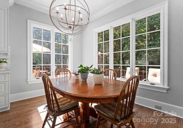 12835 Ninebark Trl, Charlotte, NC 28278 - dining area with crown molding, healthy amount of natural light, baseboards, a chandelier, and dark wood-style flooring